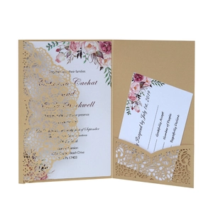Detail of laser-cut gold wedding invitation with pink peony floral card and RSVP card