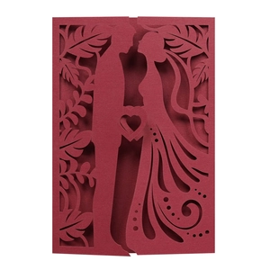 Detailed laser-cut wedding card featuring a deep red silhouette of a couple and floral patterns