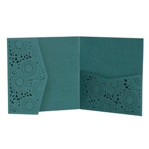 Close-up of teal laser-cut lace floral pattern on formal wedding invitation envelope