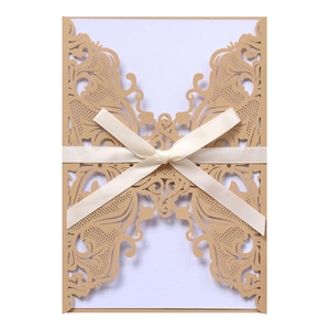 Detailed laser-cut floral invitation cover with champagne lace patterns and satin bow