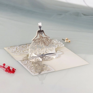 Detail of laser-cut 3D pop-up wedding invitation featuring a girl silhouette in gold
