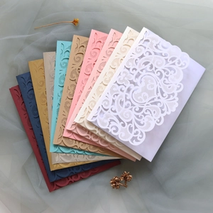 Laser-cut lace invitation covers in diverse colors for weddings and festive parties