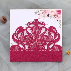 Detail showing the laser-cut glitter burgundy wedding invitation with pink floral inner card