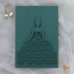 Detailed laser cut dark green wedding invitation with elegant floral lace pattern