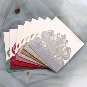 Detailed fan layout of laser-cut glitter wedding invitations in assorted metallic colors