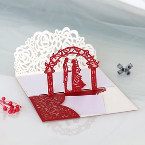Detailed macro view of laser-cut 3D pop-up rose pattern on glittery wedding card