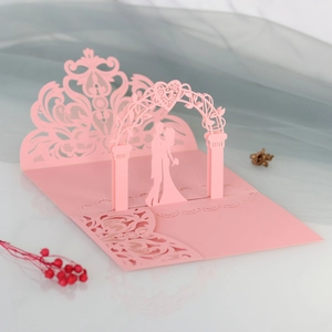 Detailed laser-cut 3D wedding card with heart arch and pink pearlescent paper finish