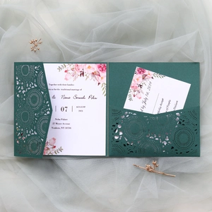 Detail of dark green laser-cut wedding invitation with elegant pink peony floral cards
