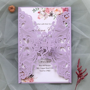 Detail of laser-cut butterfly wedding invitation in lavender with floral inner card