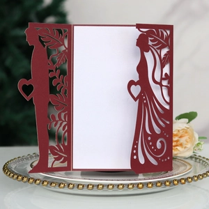 Detailed laser-cut wedding invitation featuring bridal silhouettes and floral patterns