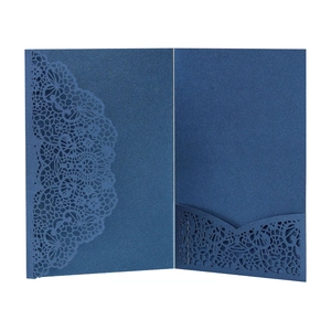 Detail of laser-cut lace pattern on deep blue pearlescent paper wedding invitation cover
