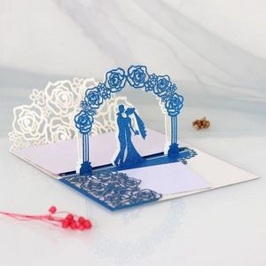 Macro view of blue glitter laser-cut pop-up wedding card with rose arch detail
