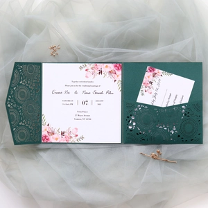 Detail showing dark green laser-cut wedding invitation pocket with floral RSVP card