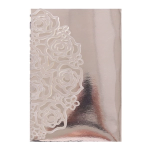 Detail of rose gold laser cut wedding invitation showing intricate floral hollow patterns