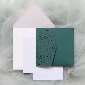 Detailed laser-cut sunflower pattern on dark green invitation card with envelope