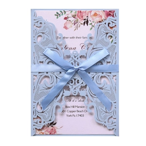 Laser cut light blue wedding invitation with pink floral insert and silk ribbon bow