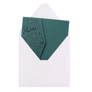 Macro detail of laser-cut lace pattern on dark green wedding invitation card