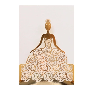 Detail of laser-cut gold wedding invitation featuring elegant female silhouette with roses