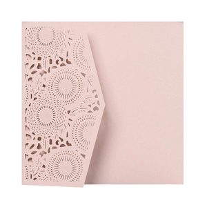 Detail of laser-cut sunflower pattern on dusty pink pearlescent paper invitation