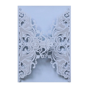 Detail of light blue laser-cut wedding invitation with intricate floral lace pattern