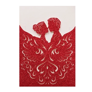 Detail of red glitter laser-cut wedding invitation featuring a romantic couple silhouette