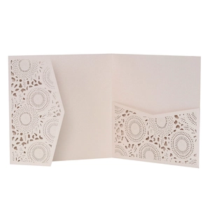 Detail showing laser-cut mandala floral patterns on beige wedding invitation card
