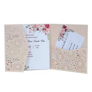 Detail of laser-cut geometric floral wedding invitation with rose printed insert card