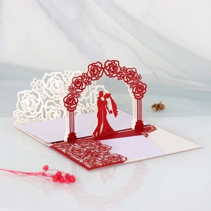 Detail of 3D pop-up wedding card featuring red glitter rose arch and bride groom silhouette