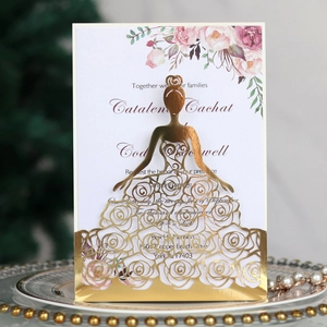 Macro view of gold laser-cut bridal silhouette invitation with floral inner card detail