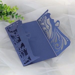 Intricate laser-cut navy blue wedding invitation cover with bride and groom silhouettes