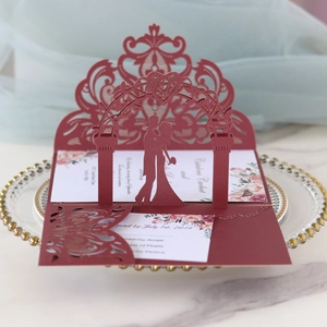 3D laser cut wedding invitation card in burgundy featuring romantic floral arch and couple