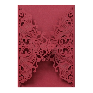 Detailed laser cut deep red wedding invitation with intricate lace floral and butterfly patterns