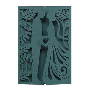 Detail of laser-cut navy wedding invitation featuring a romantic silhouette of a couple