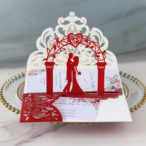 Elegant 3D laser-cut wedding invitation featuring red glitter arch and floral insert