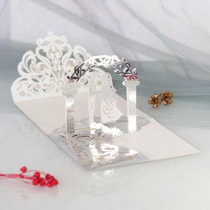 Detail of 3D laser cut wedding invitation with white paper gate and floral lace patterns