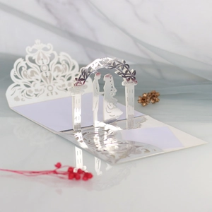 Detailed 3D laser-cut wedding invitation featuring a romantic floral arch and couple