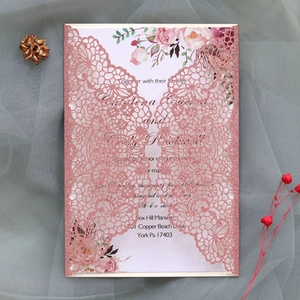 Detail of rose gold laser cut lace wedding invitation with glitter and floral inner card