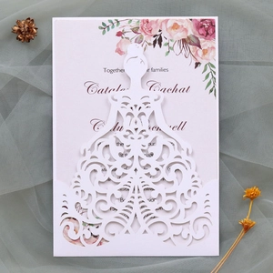 Detailed laser-cut wedding invitation featuring elegant white lace bridal dress silhouette