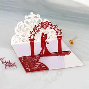 Close-up of 3D pop-up wedding invitation featuring red glitter paper and laser-cut arch