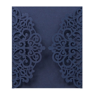 Detail of laser-cut navy blue wedding invitation with intricate lace floral pattern