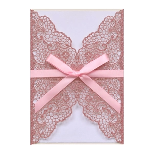 Detailed laser-cut glitter invitation with elegant pink ribbon bow decoration