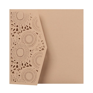 Detailed laser cut mandala patterns on rustic brown kraft paper wedding invitation card