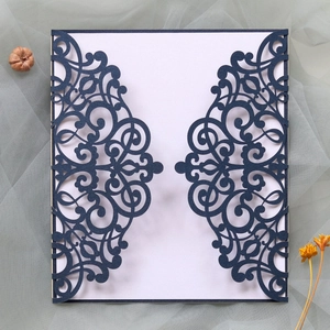 Intricate laser-cut navy wedding invitation featuring elegant European filigree patterns