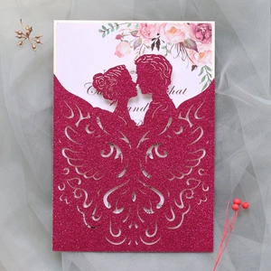 Detail of laser-cut wedding invitation featuring glitter rose red finish and floral insert