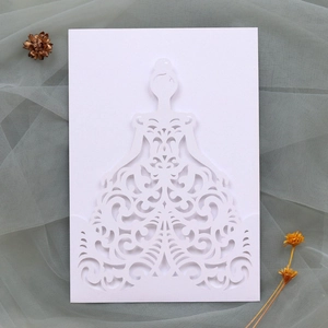 Detail of laser-cut wedding invitation featuring bridal silhouette and baroque patterns
