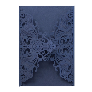 Detailed laser-cut navy blue wedding invitation cover with intricate floral patterns