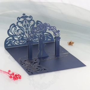 Detail of navy blue laser-cut 3D wedding invitation featuring intricate lace gate patterns