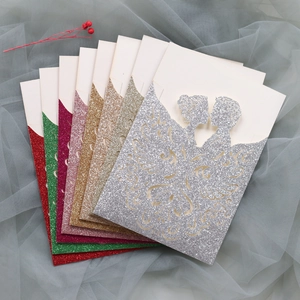 Detailed laser-cut wedding invitations with glitter finish and romantic bride and groom silhouette