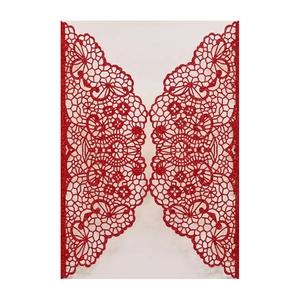 Detail of red glitter laser cut wedding invitation card with intricate lace flower pattern