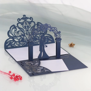 Detail of laser-cut 3D wedding invitation with navy lace and romantic couple pop-up design